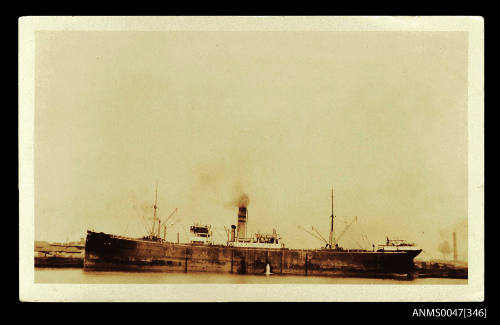 SS EVANGER docked at wharf with warehouses in background