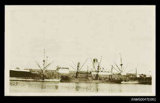 SS SOMERSET II docked at a wharf with a tender beside it