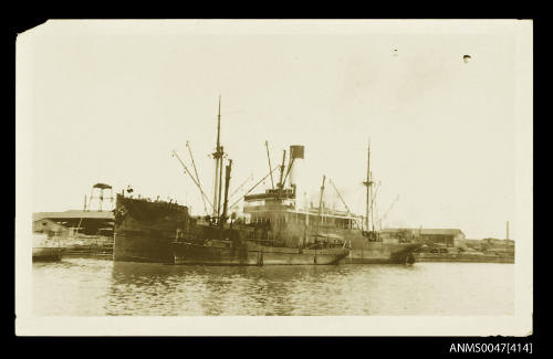 SS BURWAH docked at a wharf with tender beside it