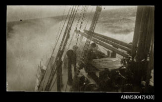 View from the bridge of the fore mast, derricks, ventilators and hatch of the bow in heavy seas