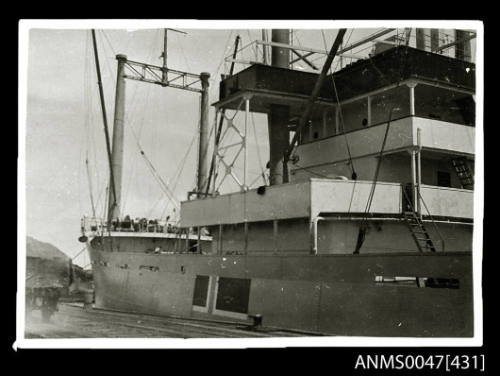 View from the wharf of the bridge and forward area port quarter of a steamship