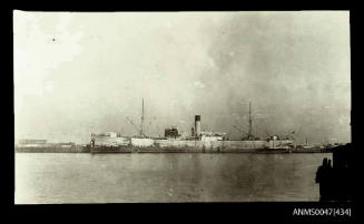 Distant view of the SS INDIANIC docked at a wharf