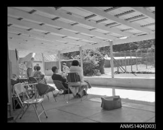 People sitting in a covered patio area, Lord Howe Island