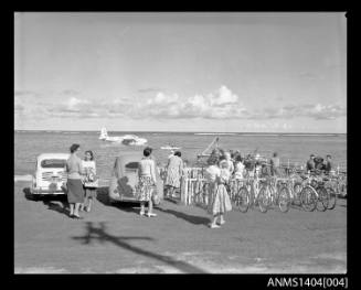 A crowd of people watching a flying boat land at Lord Howe Island