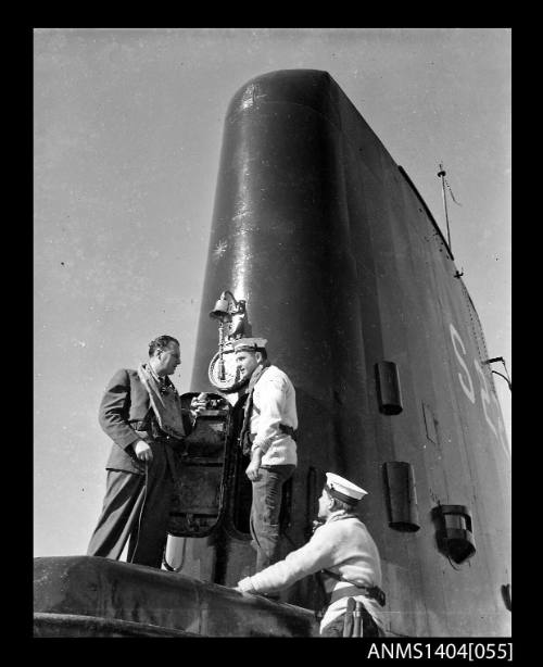 Civilian man interviewing a crew member on HMS ANCHORITE