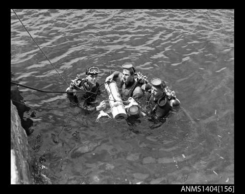 Photographic negative showing divers testing an AWA underwater television camera