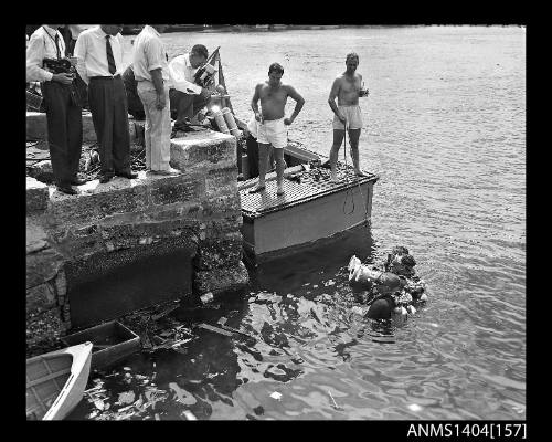 Photographic negative showing divers testing an AWA underwater television camera