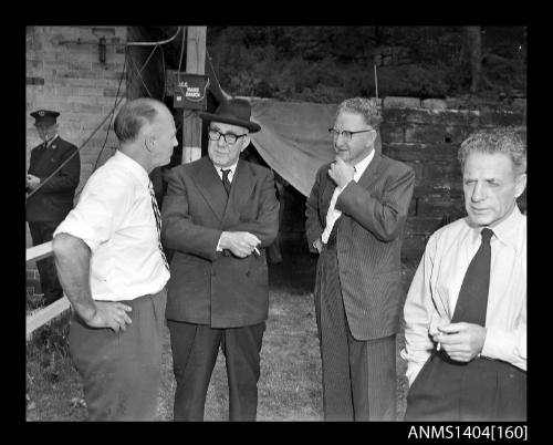 Photographic negative showing a group of men at the testing of an AWA underwater television camera