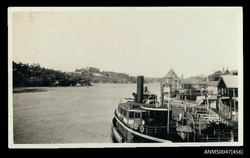 Twin decked passenger ferry alongside a suburban wharf.