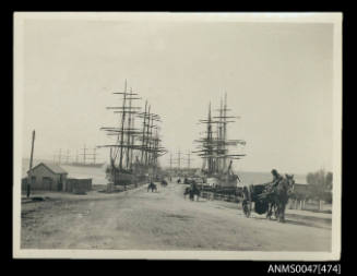 View of a working jettywith barques and sailing ships are docked on each side