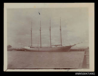 Four masted wood schooner KING CYRUS docked at a wharf