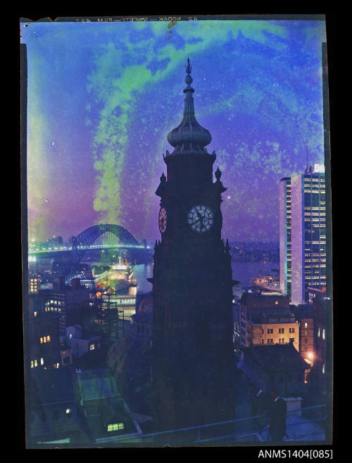 Photographic transparency showing the Lands Department building clock tower with ships CANBERRA and BULOLO in background, Circular Quay