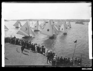 Spectators standing at Clark Island to view the start of an 18 Foot yacht race