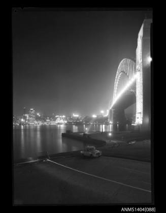 Photographic negative showing the Sydney Harbour Bridge and Circular Quay at night time