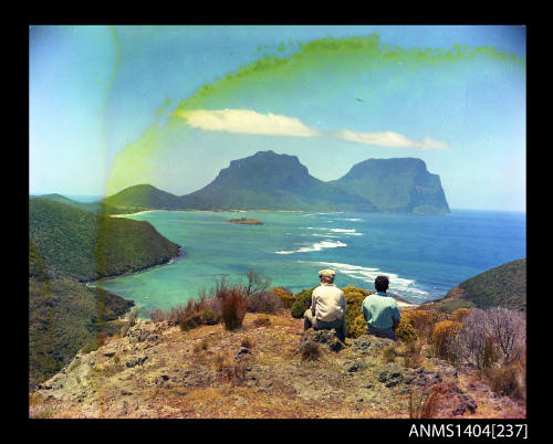 Photographic transparency showing two people admiring the view across the lagoon on Lord Howe Island