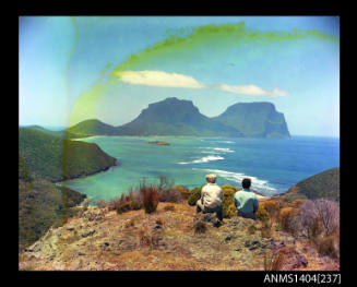 Photographic transparency showing two people admiring the view across the lagoon on Lord Howe Island