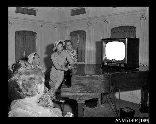 Photographic negative showing a group of women watching an AWA television aboard the ship TAIPING