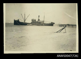 SS KURNALPI port side view, at anchor with jetty close to stern