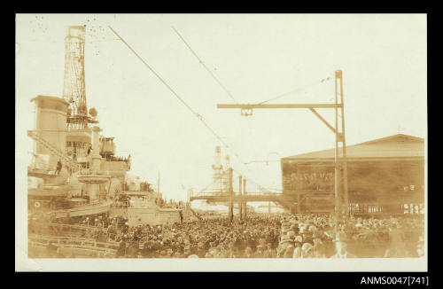 Large warship berthed at a wharf