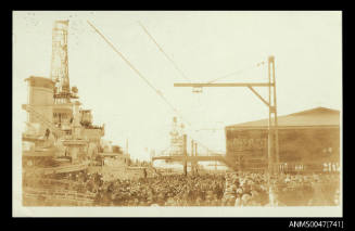 Large warship berthed at a wharf