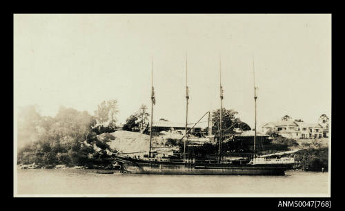 Four masted ship at anchor with building Oregon Mill in background