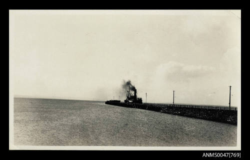 Jetty with a steamship docked at the end of it