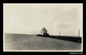 Jetty with a steamship docked at the end of it