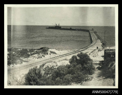 Jetty viewed from the shore, a steamship at the very end it