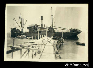 Jetty with a small steamship being loaded