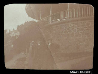 Three people standing at base of a rotunda