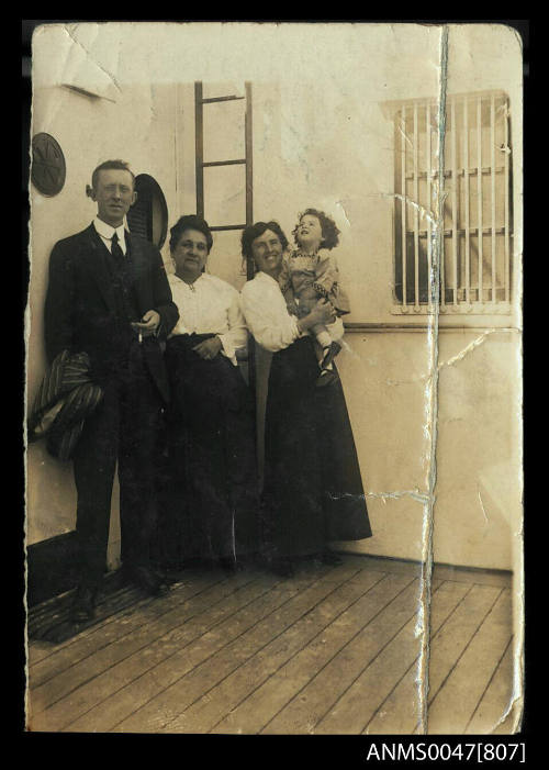 Group portrait on the deck of a ship - two women, a man and a child
