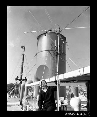 Photographic negative showing an Australian Oriental Line sailor with a television aerial on board the ship TAIPING