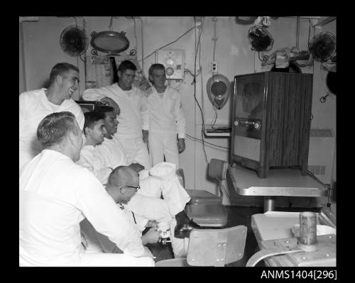 Photographic negative showing American sailors watching television on board a ship