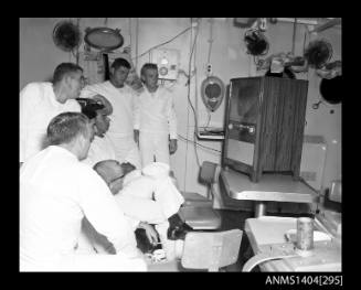 Photographic negative showing American sailors watching television on board a ship