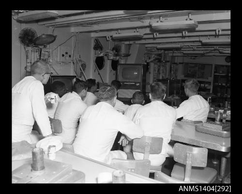 Photographic negative showing American sailors watching television on board a ship