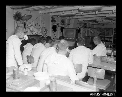 Photographic negative showing American sailors watching television on board a ship