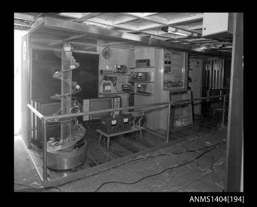 Photographic negative showing set up of an AWA company display on board a trade ship