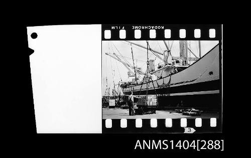 Photographic negative strip showing a cargo vessel being loaded