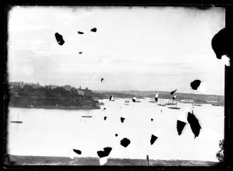 Glass plate negative image of a headland, center left,  with moored sailing boats in the water