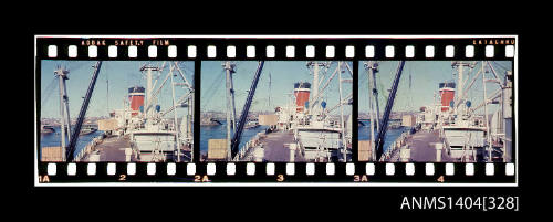 Photographic slide film showing wooden crates being loaded onto a Blue Star Line ship with Glebe Island Bridge in background