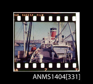 Photographic slide film showing wooden crates about to be loaded onto a Blue Star Line ship with Glebe Island Bridge in background