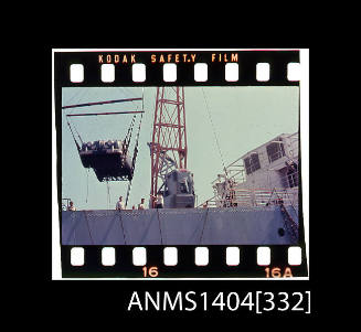 Photographic slide film showing a Jaguar car being loaded onto a cargo vessel
