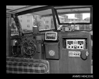 Photographic negative showing AWA brand communications equipment on board a small cruiser