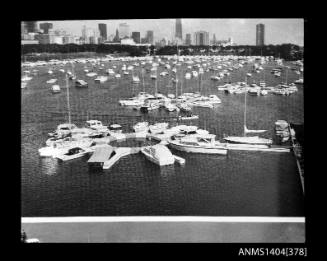 Photographic negative showing a view of boats moored at a marina