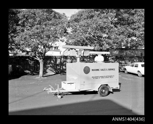 Photographic negative showing an AWA Marine Sales and Service trailer