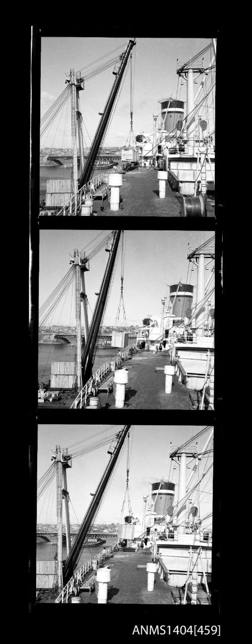 Photographic negative strip showing images of wooden crates being loaded onto a Blue Star Line ship with Glebe Island Bridge in background