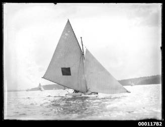 18-foot skiff with oblong and diagonal band sail insignia, heads up Sydney Harbour