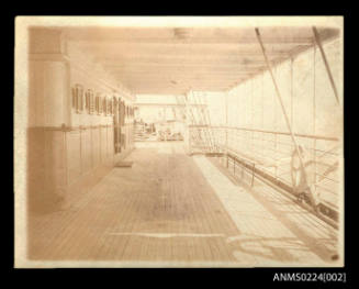 Deck of unknown ship, left accommodation area, wooden shutters and top centre, metal beams supporting deck above