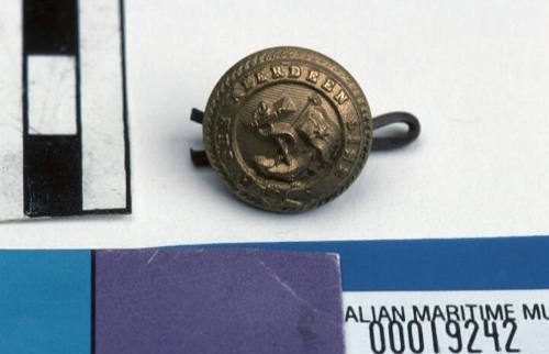 Aberdeen White Star Line small round brass button with gilt on front with raised relief pattern of fouled anchor with flag pole and flag with single star and line through middle