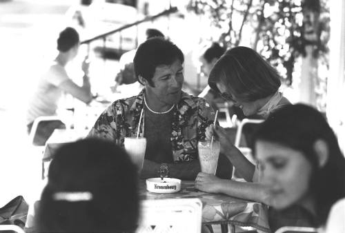 Photograph depicting a couple having milkshakes